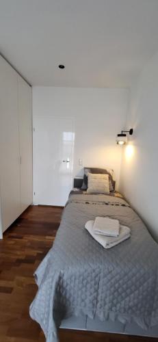 a bedroom with a large bed with two towels on it at Apartament JB 56m2 parking,balkon,2sypialnie in Legnica