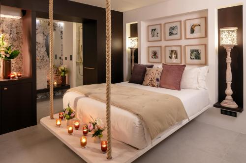 a bedroom with a hanging bed with candles on a table at Les Chambres Romantiques - JACUZZI Privatif, Domaine Aixois d'exception in Aix-en-Provence