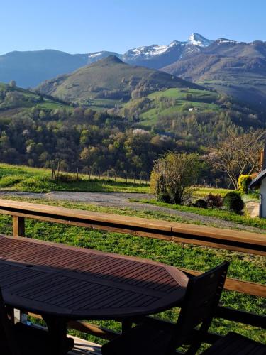 a wooden bench sitting in front of a mountain at Chalet dans les Hautes- Pyrénées entre Lourdes et Bagnères Calme et Vue magnifique in Arrodets-ez-Angles