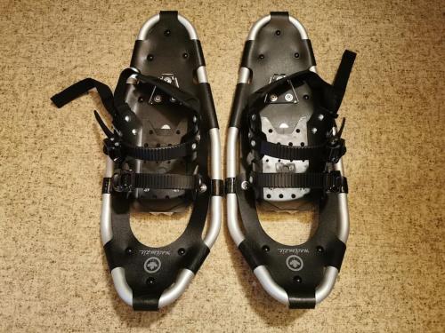 a pair of black shoes sitting on the floor at Arctic Cabin Lyngen in Svensby
