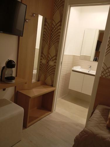 a small bathroom with a sink and a mirror at Da Mario Affittacamere in Gioia Tauro