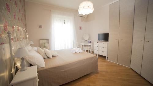 a bedroom with a bed and a dresser and a window at Vatican Sunshine in Rome