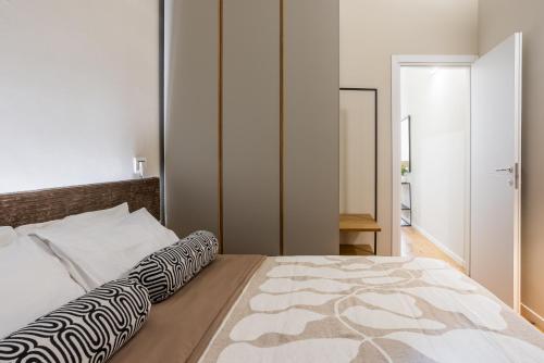 a bedroom with a large bed with a zebra patterned pillow at Duomo 9 - Luxury Modern Loft in Milan