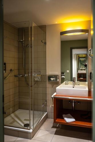 a bathroom with a shower and a sink at Hotel Lamm Baiersbronn Mitteltal in Baiersbronn