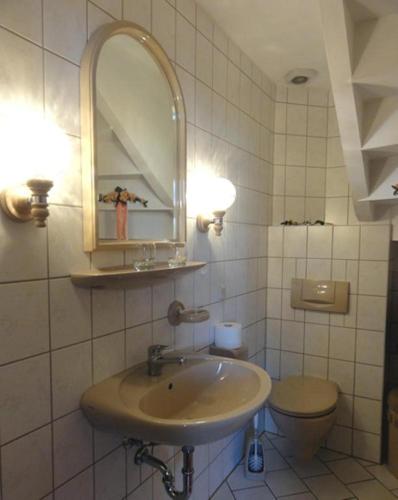 a bathroom with a sink and a toilet at Ferienwohnungen Christel in Wernigerode