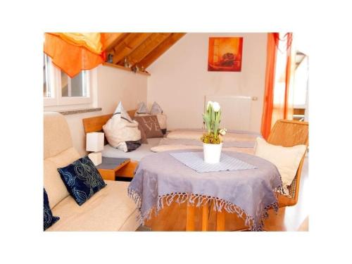 a living room with a table and a couch at Appealing apartment with terrace in Eichstetten