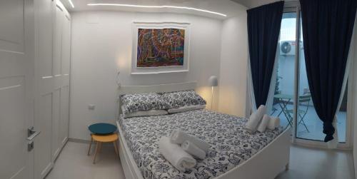 a bedroom with a bed with pillows and a painting at Da Nonno Ciccio 2 in Valenzano
