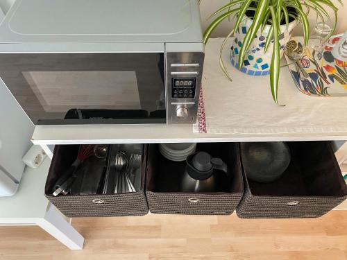 a microwave inside of a cabinet withartments at Husrum på Österlen in Tomelilla