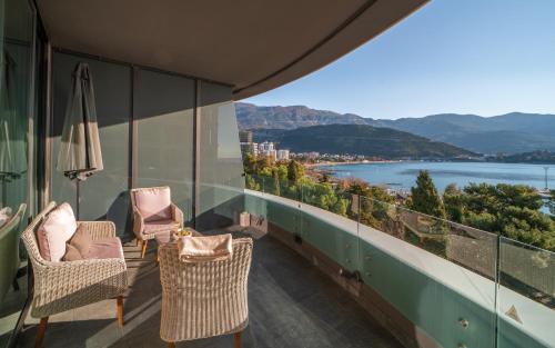 a balcony with chairs and a view of the water at Amare Luxury Apartments in Budva