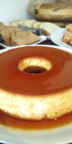 a piece of cake on a plate with caramel sauce at Morena Jambo in Arraial d'Ajuda