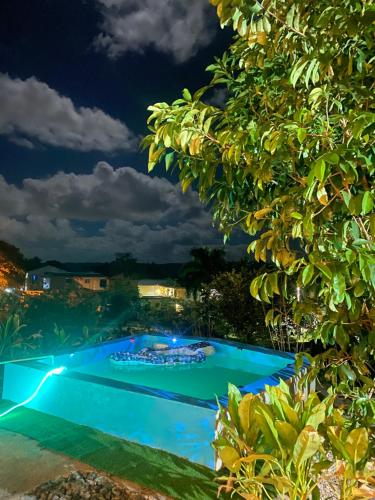 a view of a swimming pool at night at Villa Alpina in San Felipe de Puerto Plata