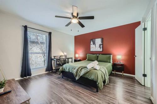 a bedroom with a bed and a ceiling fan at Your Modern 2B Getaway - W/D, Pool, Prkg - 10min to DTWN in Austin