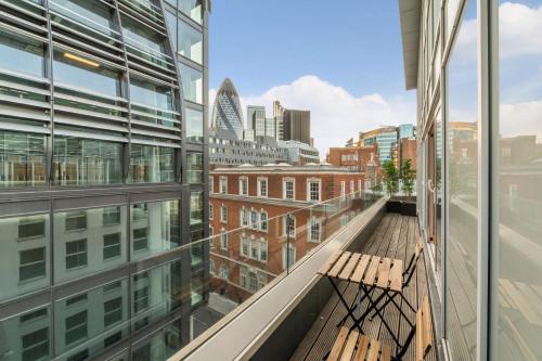 a balcony with two benches and a view of the city at Stay Kula London - Tower Hill in London