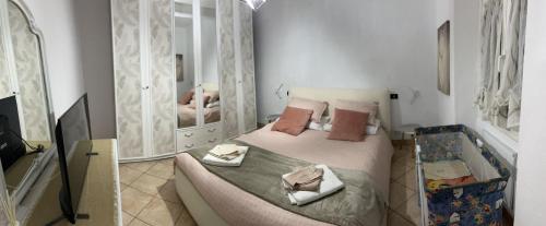 a bedroom with a bed and two mirrors at Seal Home in Genoa