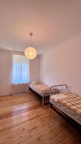 a room with two beds and a window at House & Wine in Kutaisi