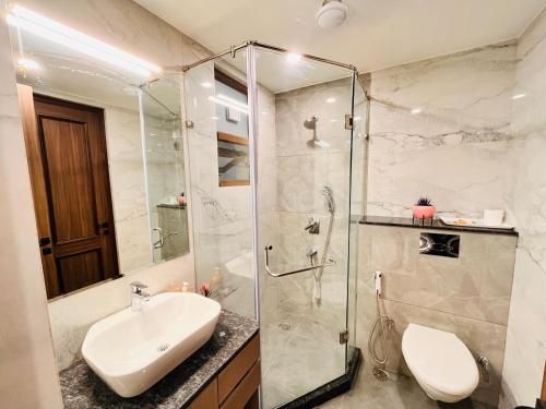 a bathroom with a sink and a glass shower at Hotel Gianmala Residency South Extension near AIIMS Delhi in New Delhi