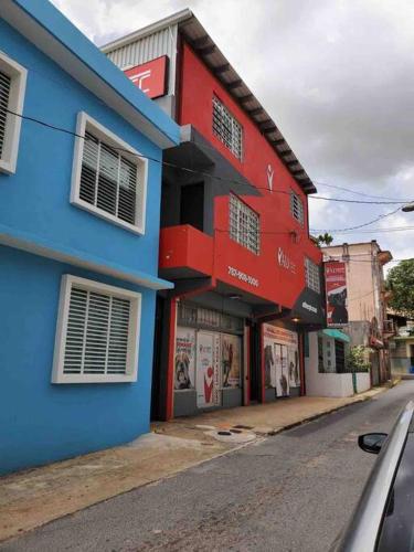 a blue and red building on the side of a street at Sweet Sunset II- Rompeolas Beach in Aguadilla