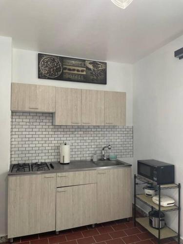 a kitchen with a sink and a counter top at Sweet Sunset II- Rompeolas Beach in Aguadilla