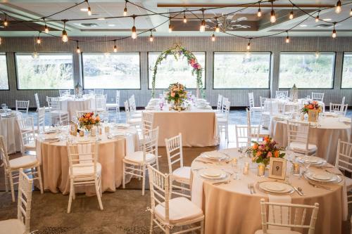a wedding reception with white tables and chairs and flowers at Holiday Inn Milwaukee Riverfront by IHG in Milwaukee