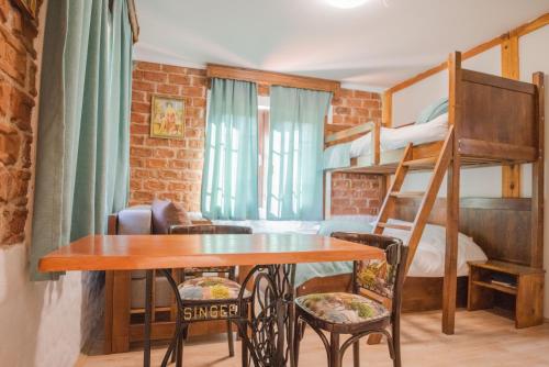 a small room with a bunk bed and a table and chairs at Apartment in Antique Museum Filip in Bitola