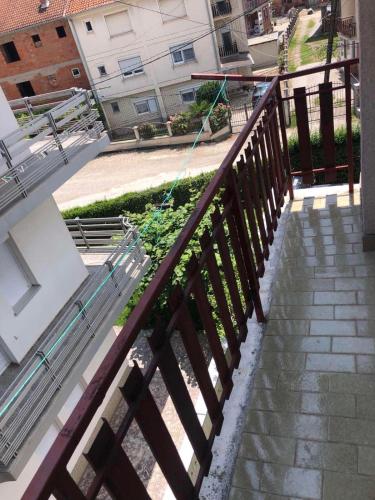 a kite is flying over a wooden railing at Rooms Struga in Struga