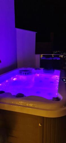 a purple bathroom with a tub filled with purple dye at Euphoria luxury penthouse in Kavala