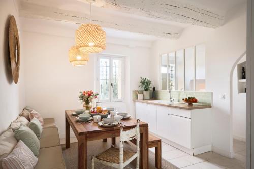 a kitchen and living room with a table and a couch at Les Remparts de Vence in Saint Paul de Vence