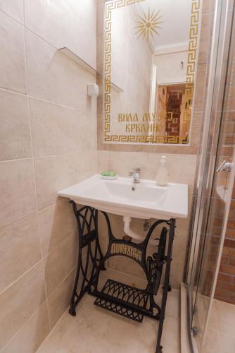 a bathroom with a sink and a mirror at Apartment in Antique Museum Filip in Bitola