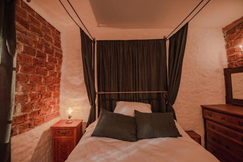 a bedroom with a canopy bed with two pillows at Apartment in Antique Museum Filip in Bitola