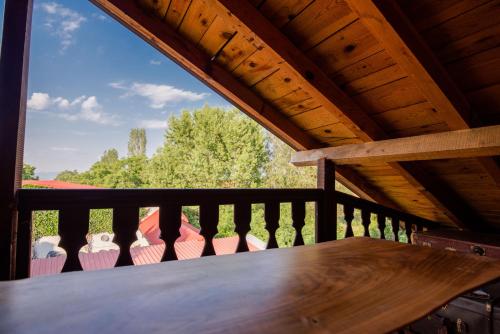 a wooden table on a balcony with a wooden roof at Apartment in Antique Museum Filip in Bitola
