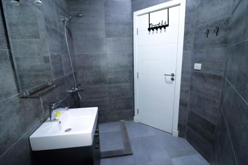 bagno con lavandino e porta bianca di Imperial Resort - Bali Themed - 1 Bed a Hurghada