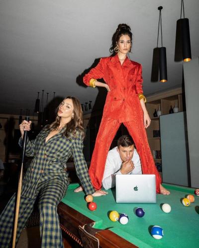 a woman standing on a pool table next to a man at Pyra Hospitality West Pyramids Cairo in Cairo