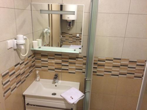 a bathroom with a sink and a mirror at Apartments Andrejic in Kopaonik