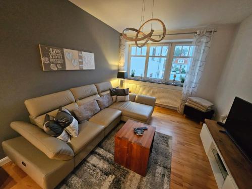 a living room with a couch and a coffee table at Strandallee 150a in Timmendorfer Strand