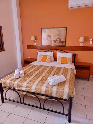 a bedroom with a bed with two towels on it at Angela Corfu in Corfu