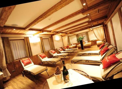 a room with a bunch of beds and chairs at Biancas Luxury Apartment close Ischgl Spa & Pool in Kappl