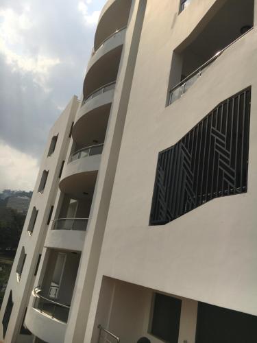 a building with balconies on the side of it at Appartements meublés de haut standing in Yaoundé