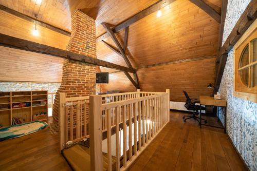 una camera con pareti in legno e una scala in una cabina di La ferme du Ravet - Gîte aux Lacs de l'Eau d'Heure a Froidchapelle