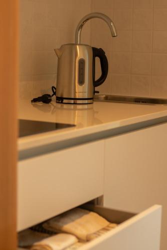 a tea kettle sitting on top of a kitchen counter at Casa da Carvoaria in Vila Real
