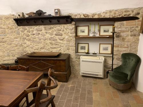 a kitchen with a table and a chair and a stove at Il Carpino luxury historic apartment in Carpineto Romano