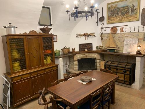 a dining room with a table and a fireplace at Il Carpino Historic Luxury Home - dimora con sauna in Carpineto Romano