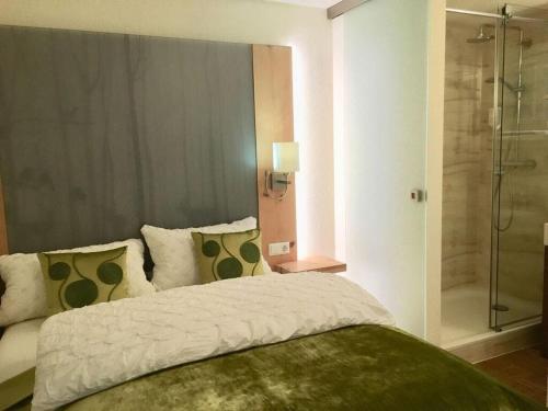 - une chambre avec un grand lit et une douche dans l'établissement Apartment Mini Suite, à Höchenschwand