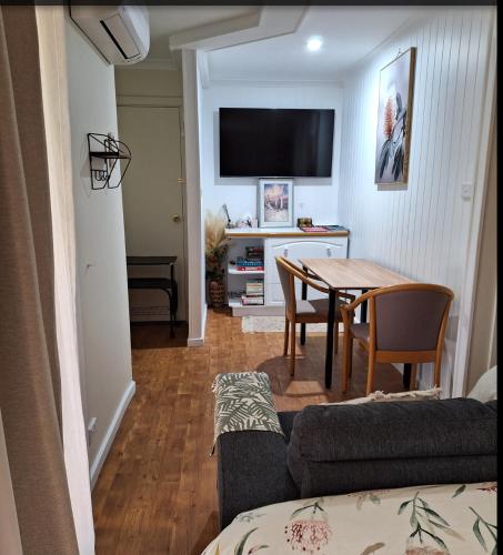 a living room with a table and a dining room at The Treasure Box in Esperance