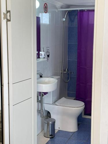 a bathroom with a toilet and a sink at Sunset studio in Pefkohori