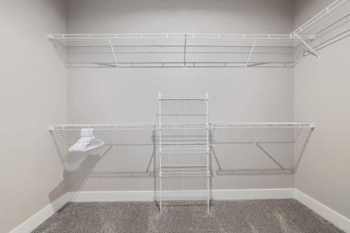 a room with white shelves on a wall at Modern 4BR 4BA Two Unit Condo w Garage and Patio in Wyoming