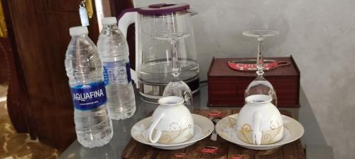 uma mesa com garrafas e pratos e um liquidificador em Pyramids kingdom - guest house no Cairo