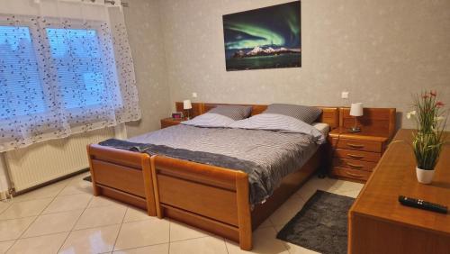 a bedroom with a bed and a desk and a window at Ferienhaus Guldner mit Terrasse, Garten und Sauna in Überherrn