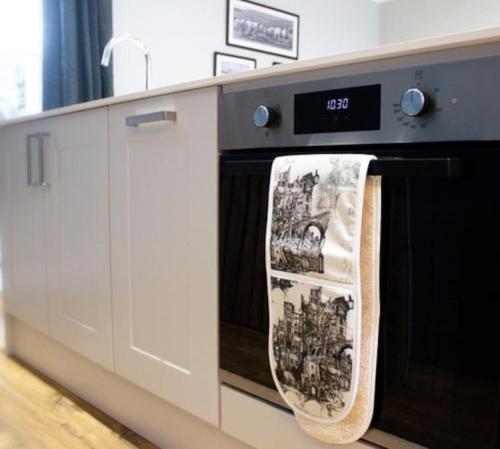 a kitchen with a dish towel hanging on a dishwasher at Central village location in Lanchester