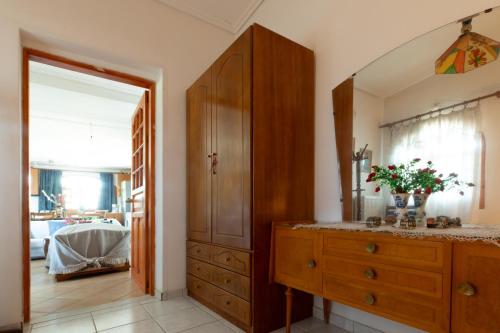 a bathroom with a wooden dresser and a mirror at Jacuzzi Pool House AMA5690 in Chalkida