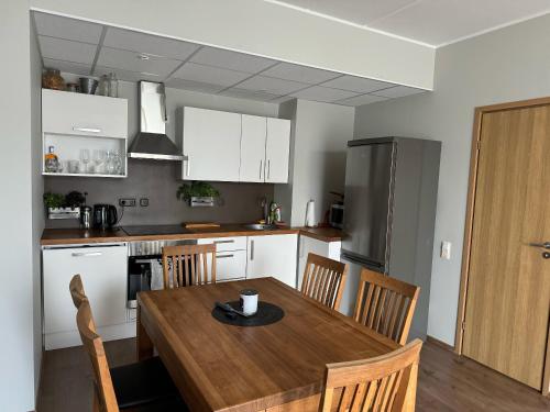 a kitchen with a wooden table and a table and chairs at Beautiful apartment with sauna in Tallinn
